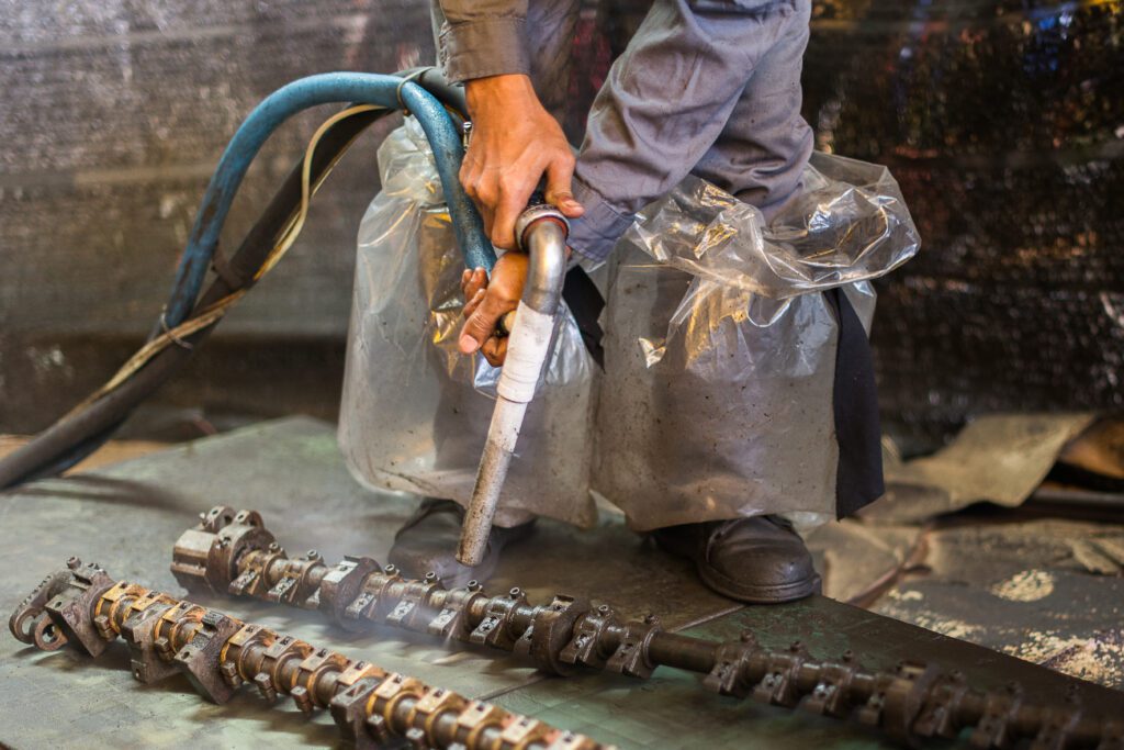 A worker is cleaning the machine equipment by using the dry ice
