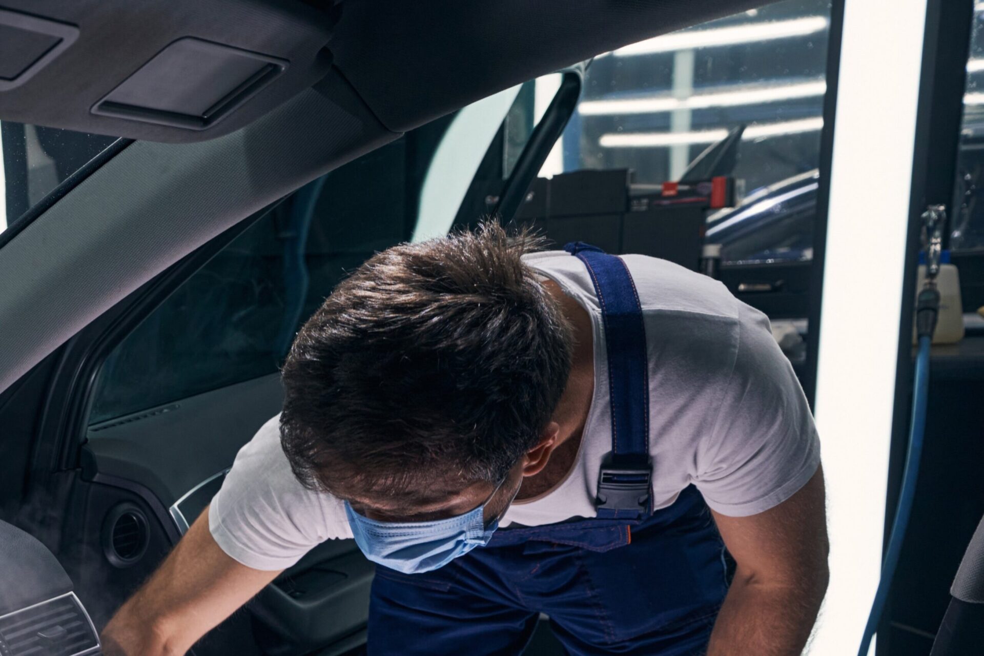 Man Leaning and Dry Cleaning Car Split Top Left Image